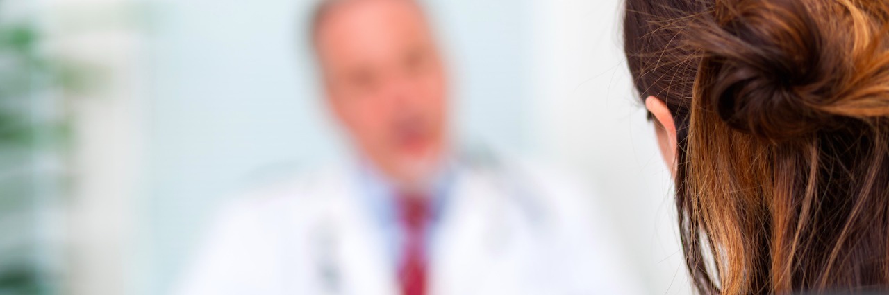 My Experience Being a Woman and Receiving an Autism Diagnosis Doctor talking to a patient in his office