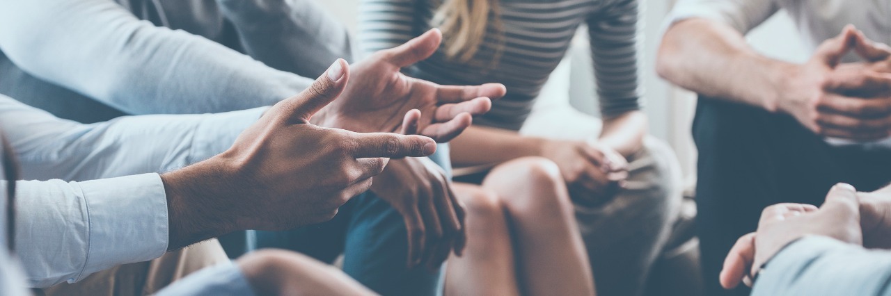 What to Do and How to Cope After IBD Diagnosis Close-up of people communicating while sitting in circle and gesturing
