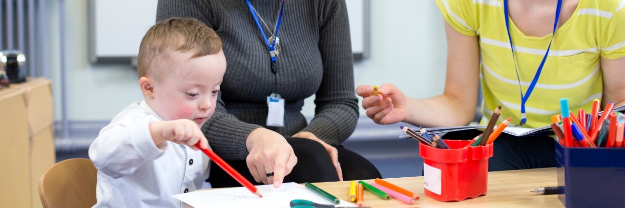 Trump Administration Marginalizes People With Disabilities Boy with Down syndrome in preschool.