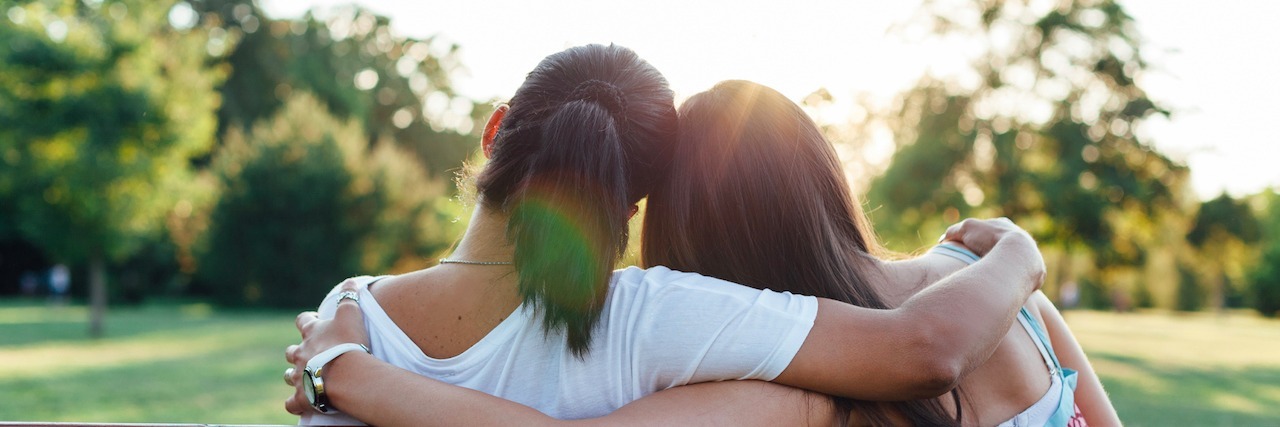 How My Mother Helped Me Accept My Anxiety Closeup of mom and daughter embracing on a park bench