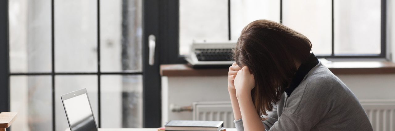 Tired business woman at workplace in office