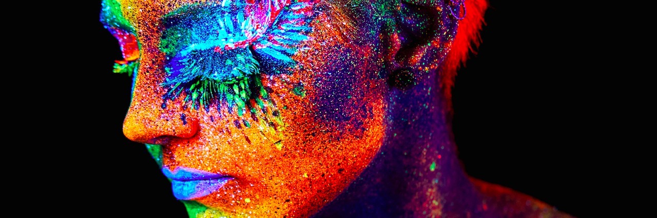 A woman with colorful paint on her face