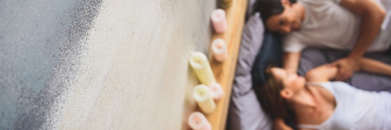 What I Want My Husband To Know About Intimacy When I'm Sick looking down on couple in bed