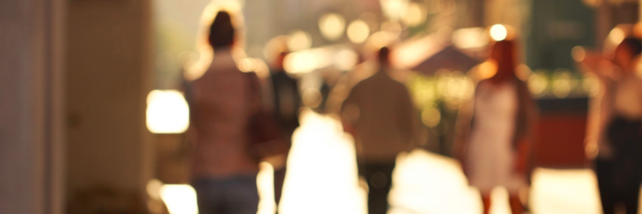 How Stimming Can Help Autistic People Self-Regulate and Reduce Anxiety Blurred background of people walking on street in city