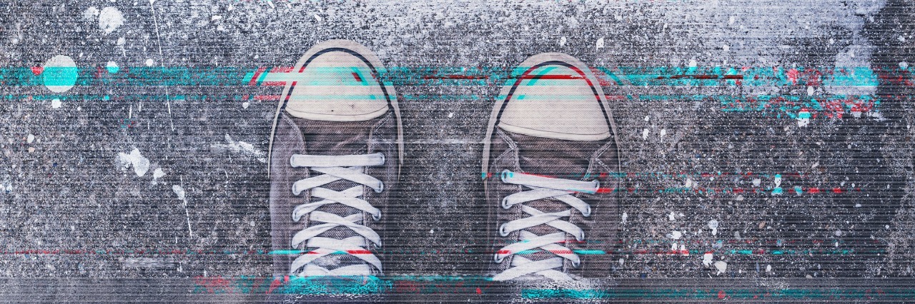 Why I Can Be Successful at Work With Crohn's Disease Pair of sneakers on pavement with digital glitch effect, young adult man standing on concrete flooring