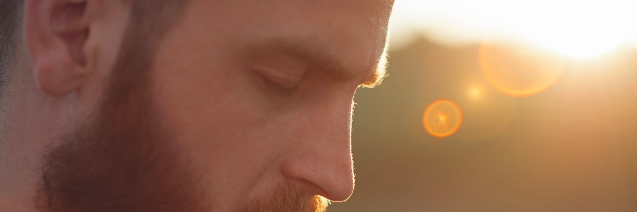 How Men Can Benefit From Meditation and Maybe Lower Suicide Statistics young bearded man with eyes closed