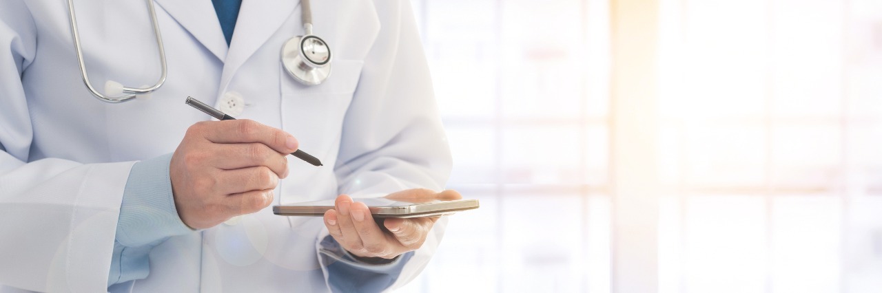 Experiencing Anxiety When You Go to a Doctor's Appointment Doctor using a smart phone in hospital. Concept of medical appointment, communication.