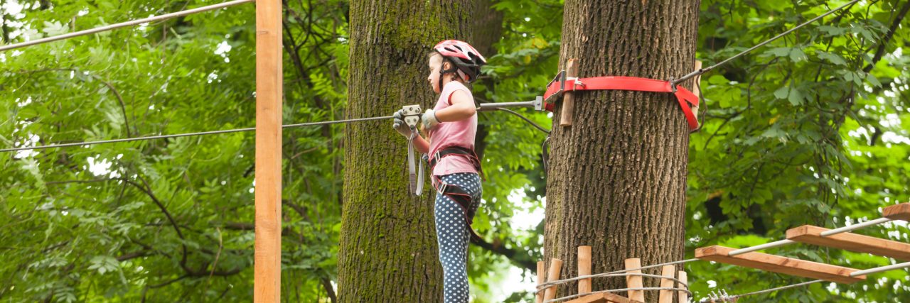 How a High Ropes Course Helps Me Cope With Depression's Bad Days Child in a adventure playground