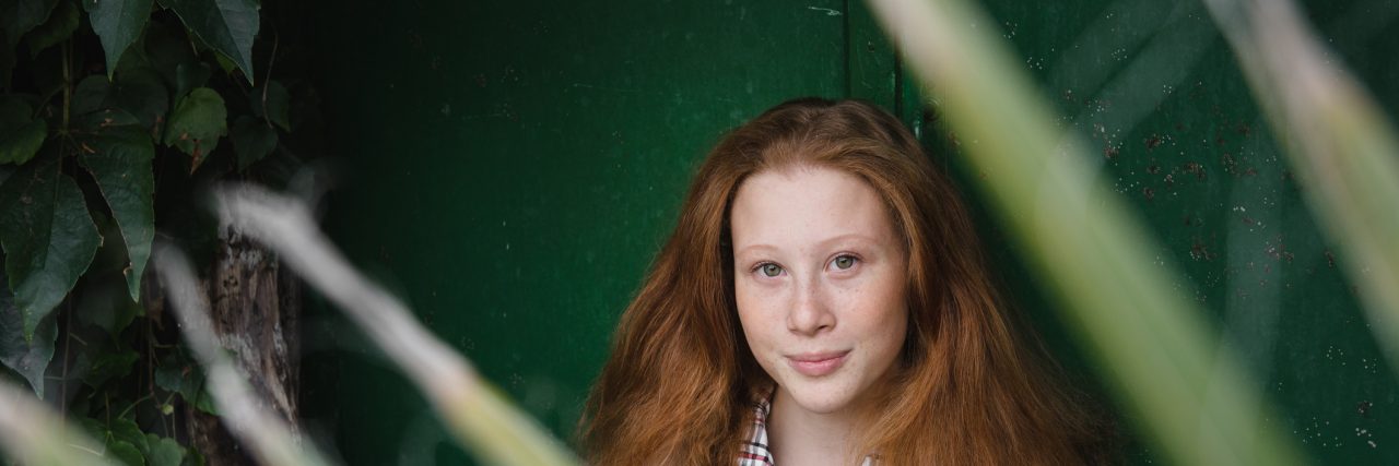 To the Person I Feel Like I’m Pushing Away With My Anxiety Portrait of red haired girl though palm tree