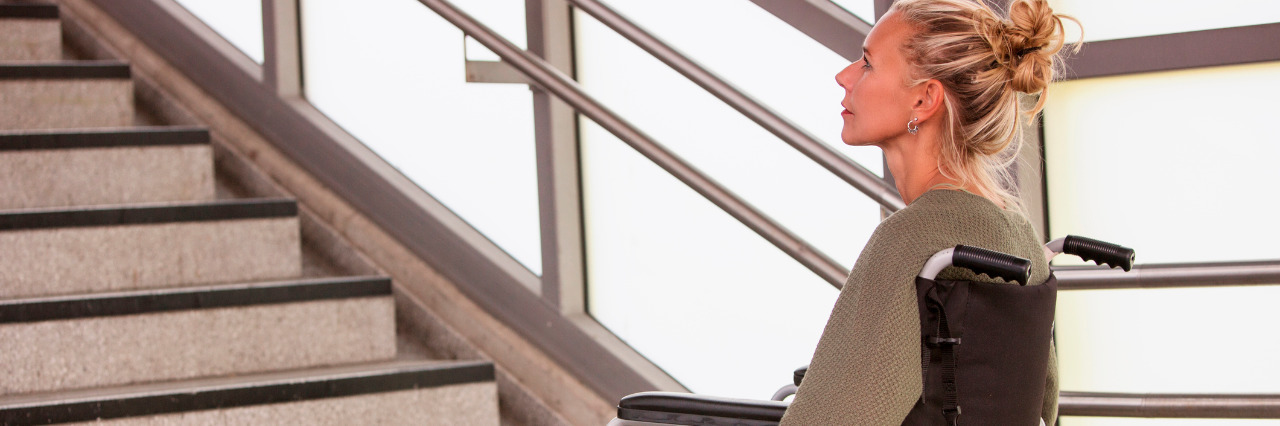 Why I Advocate Against Ableism Woman in a wheelchair in front of stairs.