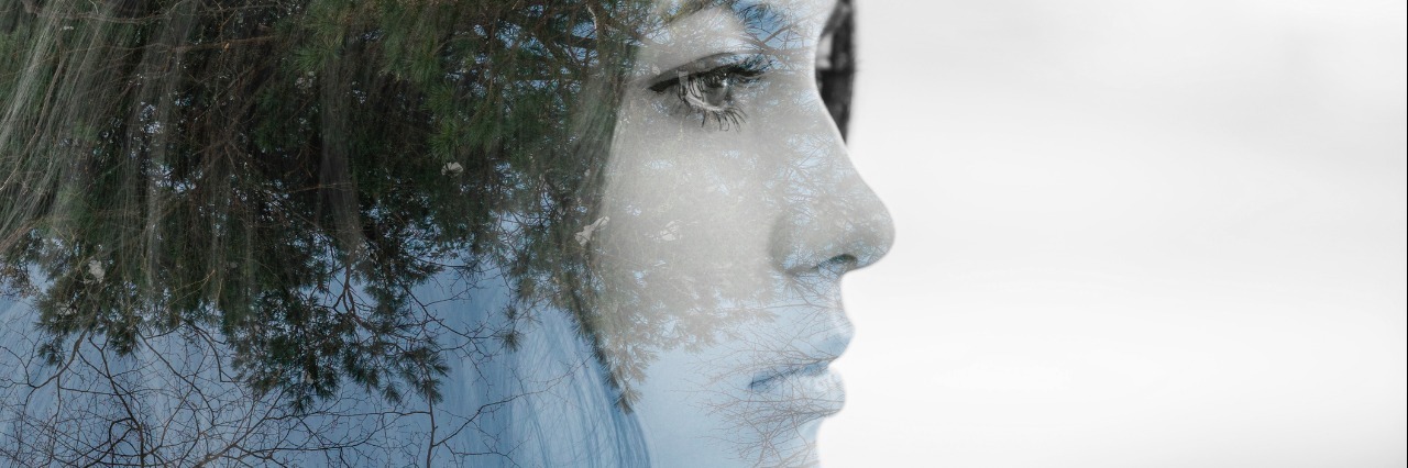 Girl in profile. Double exposure of young woman and forest.