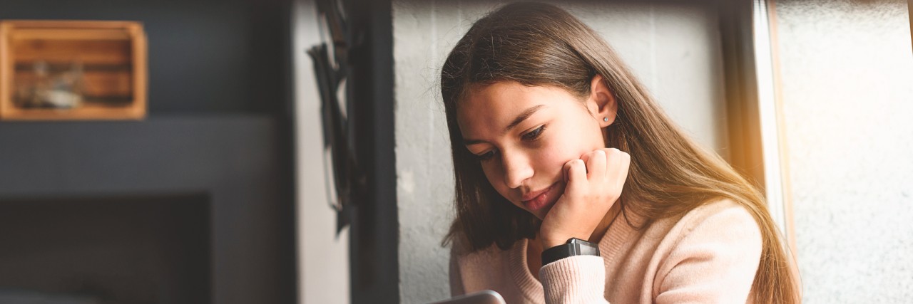 Social Anxiety and the Double-Edged Sword of Social Media Thoughtful girl looking at screen
