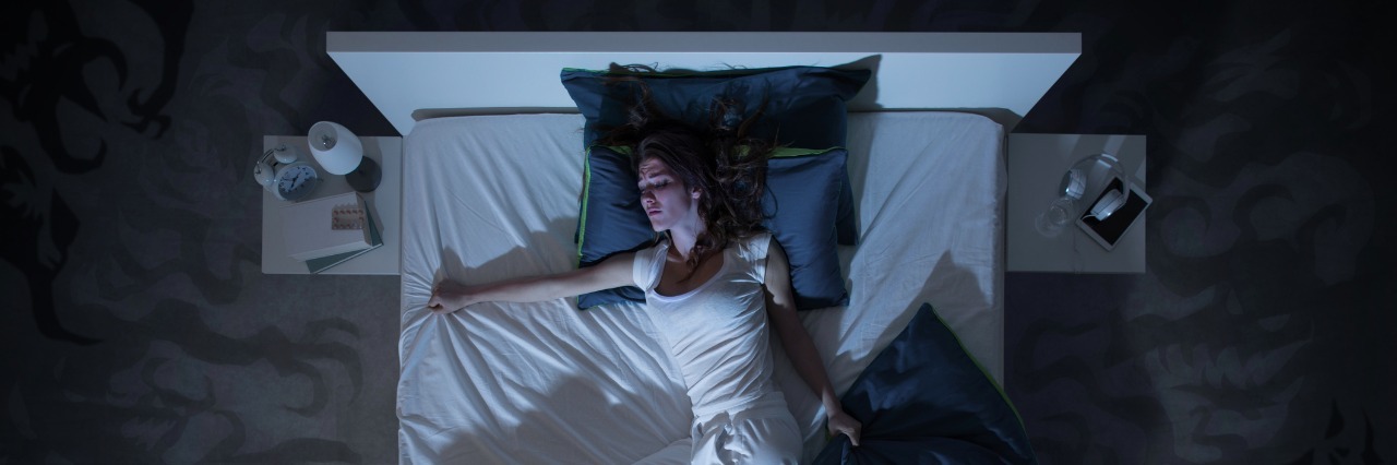 woman grabbing edge of her bed