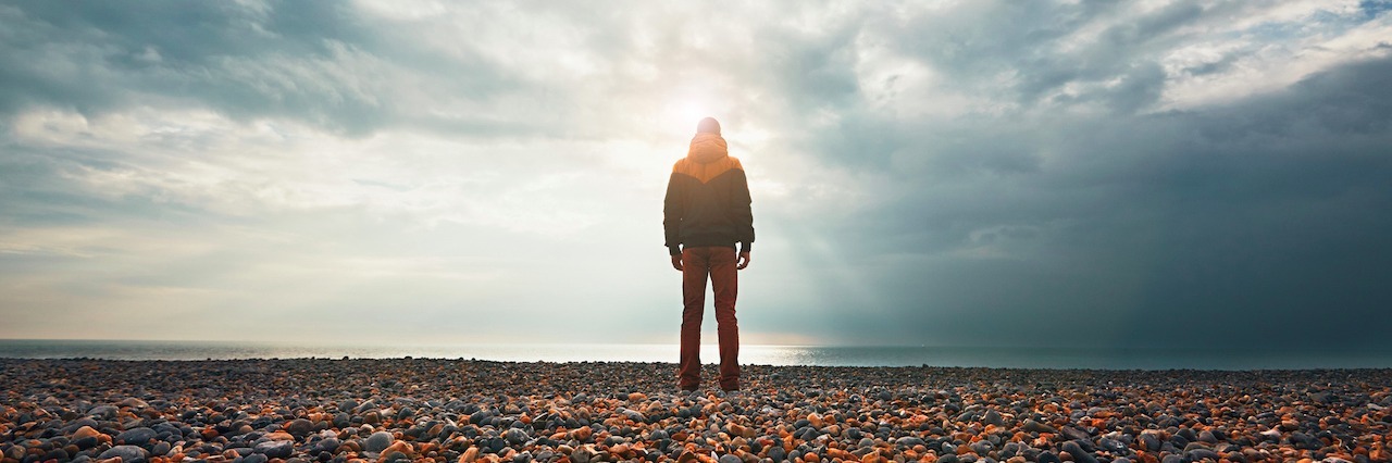 What Keeps Me Fighting Through My Struggle With Depression a man standing on rocks