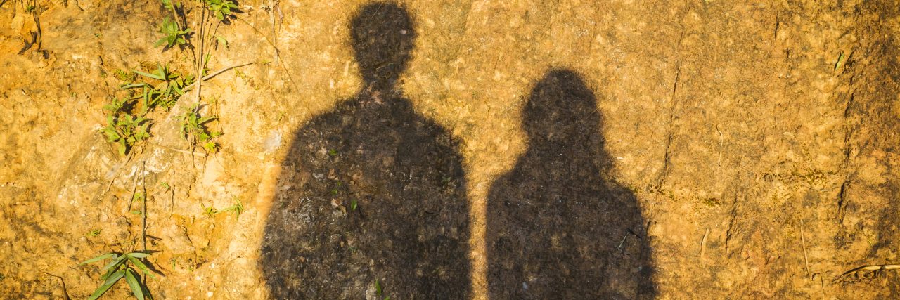 The Shadows of Anxiety and Depression Shadow of man and the woman on dirty ground.