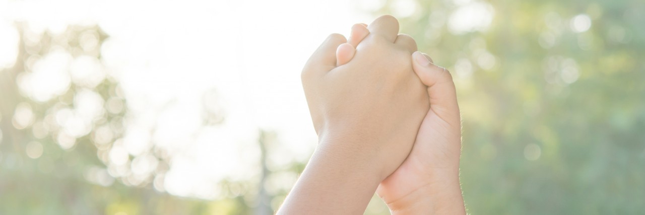 My Ultimate Guide to Online Fibromyalgia and Chronic Pain Support hands Sporting local children on playground