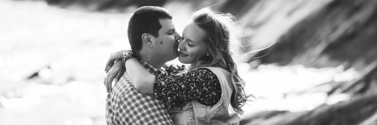 How to Love Someone With a Mental Illness Young beautiful couple together near sea. Embrace, enjoy and kis