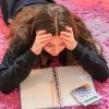 Girl struggling with her math homework.