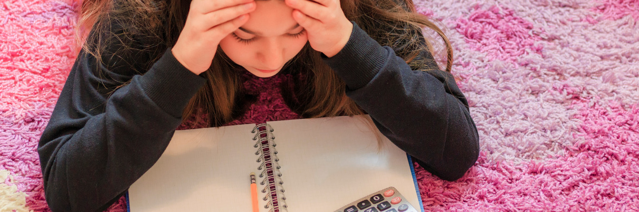 Struggling in the Education System With Multiple Disabilities Girl struggling with her math homework.