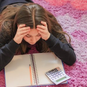 Girl struggling with her math homework.