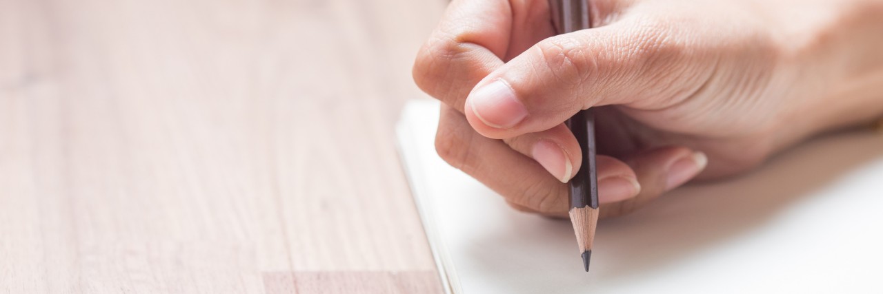 The Healing Power of Writing in a Journal Through Depression Hands writing on notebook
