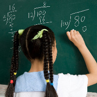 Girl writing on blackboard.