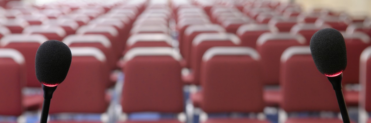 Why Schools Need to Support Students Speaking About Mental Health empty seats and two microphones