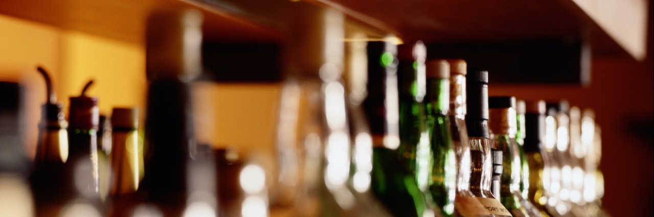 How to Be Sober in Your 20s Shelf of liquor bottles