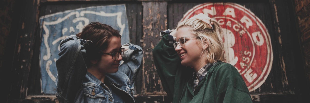 A Letter From Your Best Friend With OCD friends smiling at each other in front of a big door
