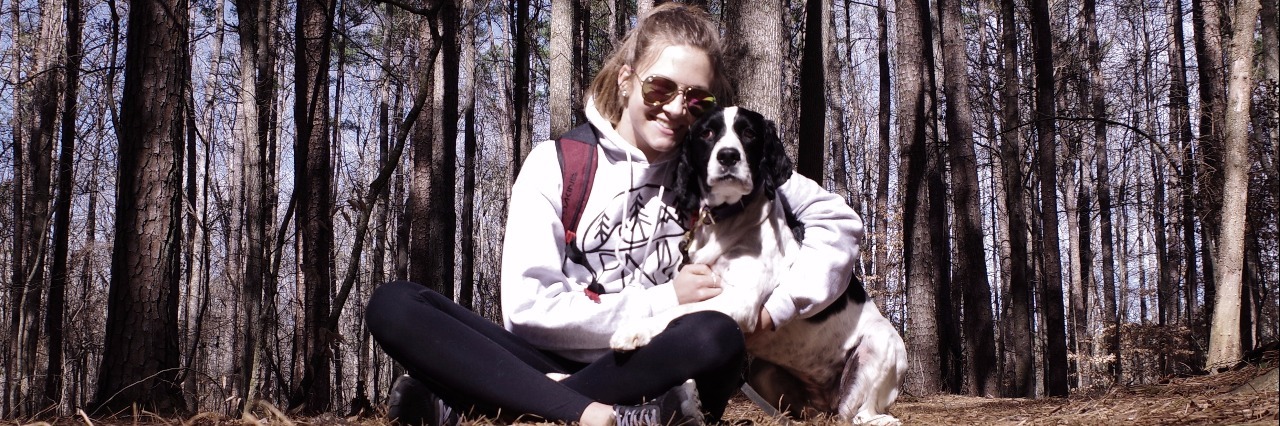 How to Celebrate Your Birthday When You Have Lyme Disease girl sitting in woods with dog