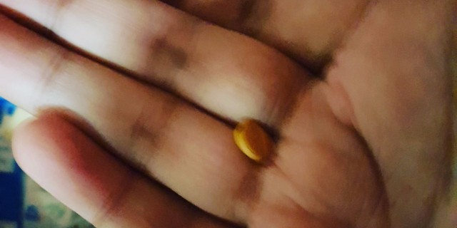 Chemo Starts Tomorrow, and I'm Looking Forward to It picture of a hand with a yellow pill int he middle