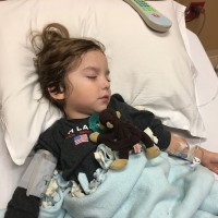 little boy asleep in the hospital