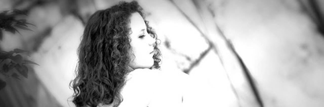 How My Nursing Degree Affected My Multiple Sclerosis Diagnosis black and white photo of woman from behind wearing sweatshirt