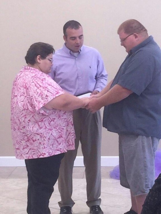 man and woman facing each other holding hands