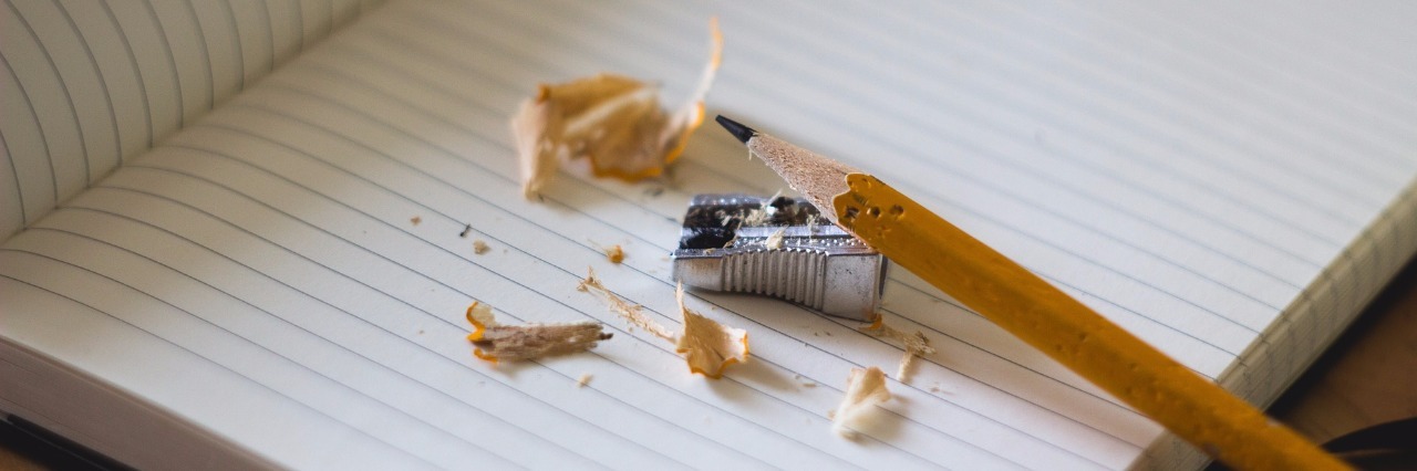 pencil with shavings and sharpener on lined notebook