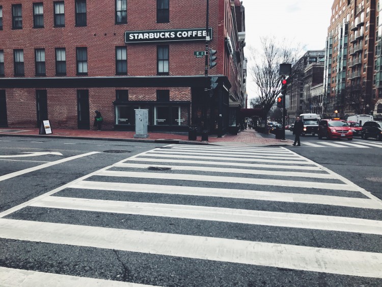 image of crosswalk in front of brick building and starbucks coffee sign