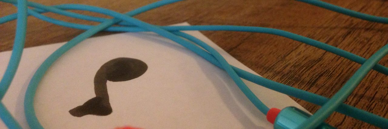 I Never Expected Depression to 'Take' My Love of Music paper with music note on it and headphones nearby