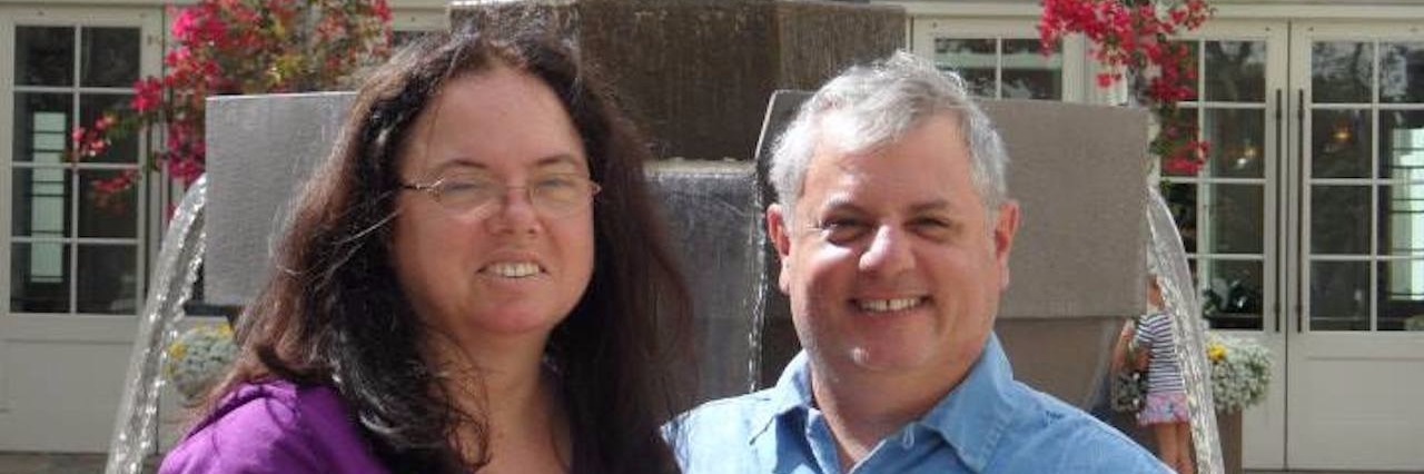 Letter to My Husband Who Supports My Mental Health Recovery Contributor and husband in front of yoda statue