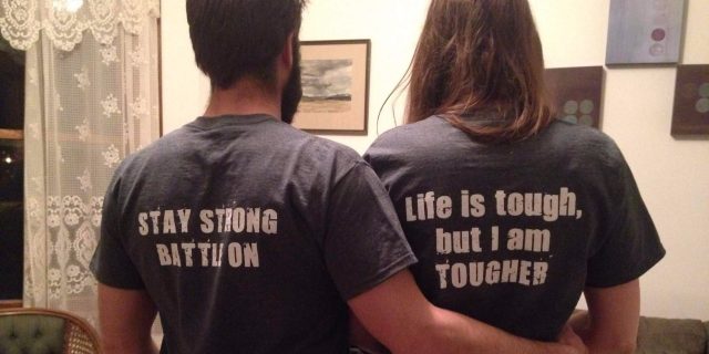 husband and wife wearing t-shirts that say 'stay strong, battle on' and 'life is tough, but I am tougher'
