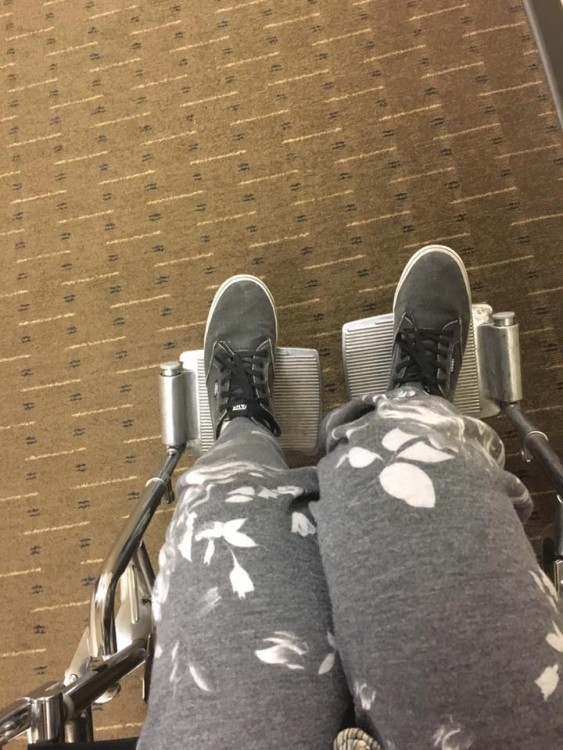 woman's legs wearing sweatpants in wheelchair