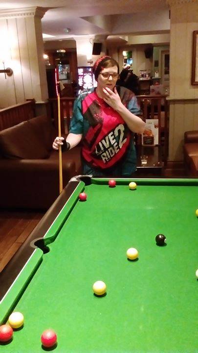 woman standing behind pool table