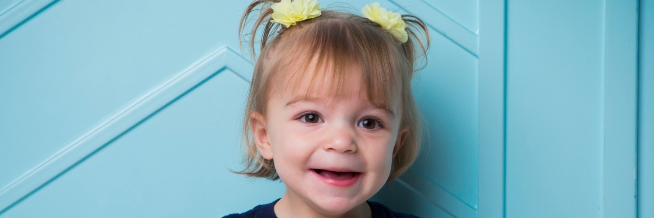 Our Daughter Has a Genetic Mutation on the SHANK2 Gene smiling little girl with shank2 gene mutation