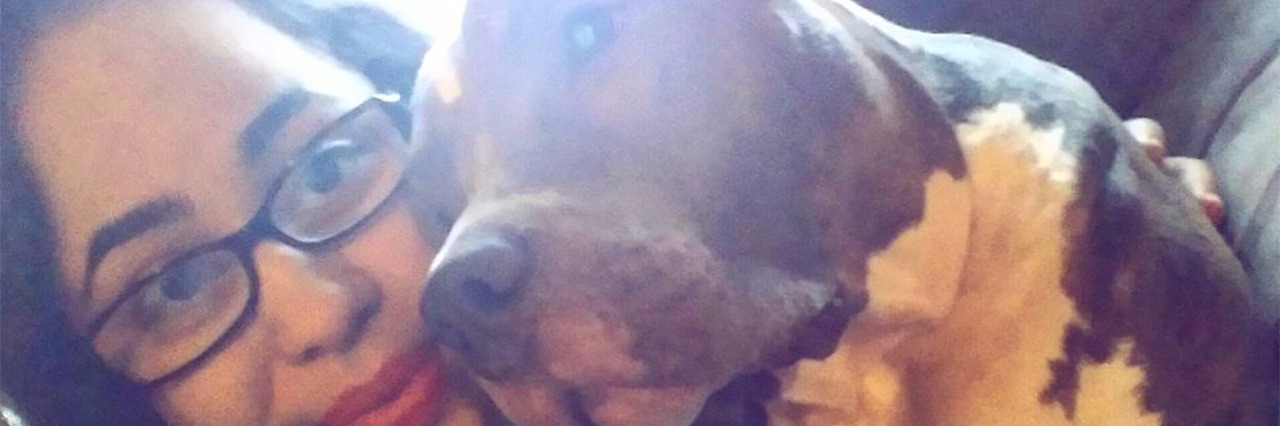 Why My Dog Is My Weapon Against My Anxiety and Depression girl smiling with pit bull terrier dog