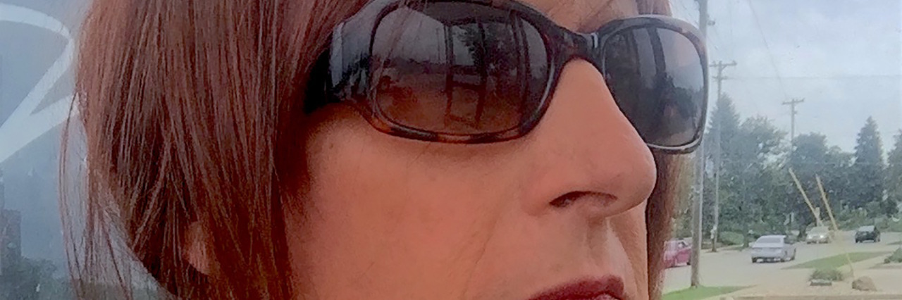 Living With Blindness Can Open Windows of Perception Carla standing outdoors near the bus.
