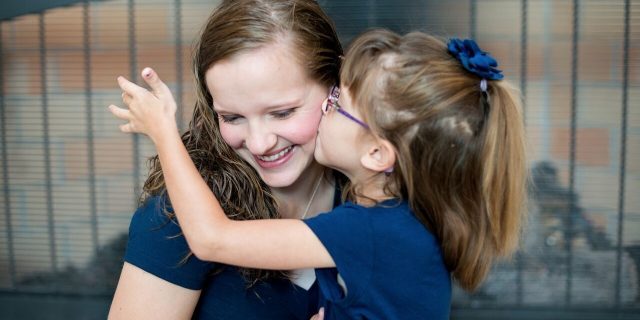 What I Wish I Knew When My Daughter Was Diagnosed With SATB2 Syndrome young daughter kissing her mother on the cheek