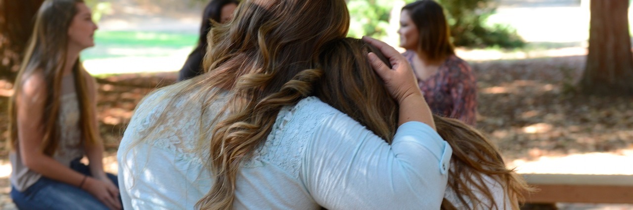 How Do I Help a Friend With an Eating Disorder? Back view of two girls hugging each other