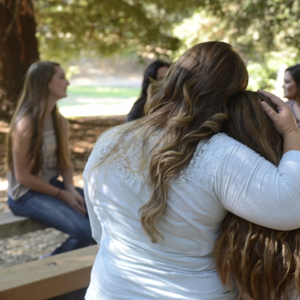 Back view of two girls hugging each other