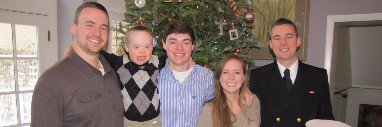 Alzheimer's Disease, a Threat to My Son's Future With Down Syndrome Doyle family posing in front of a Christmas tree