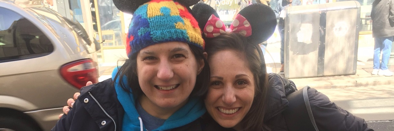 Two women dressed as Mickey and Minnie Mouse holding a sign for Ellen Degeneres Show