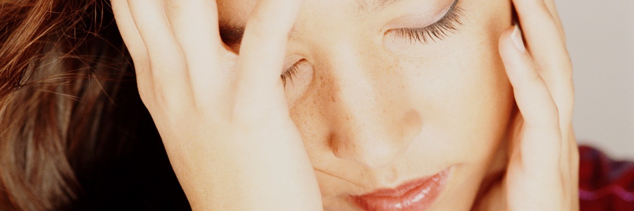 Close-up of woman holding her head